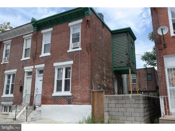 a view of a brick house with many windows