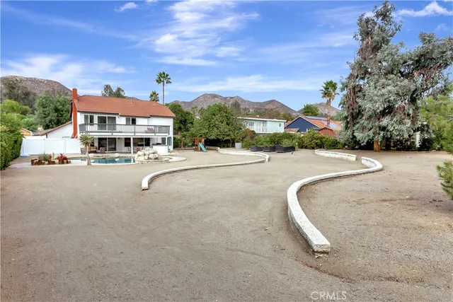 a swimming pool with outdoor seating and yard