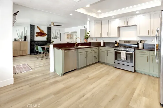 a kitchen with stainless steel appliances granite countertop a stove and a refrigerator