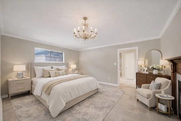 a bedroom with bed and a chandelier