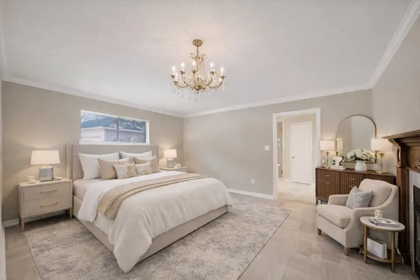 a bedroom with bed and a chandelier