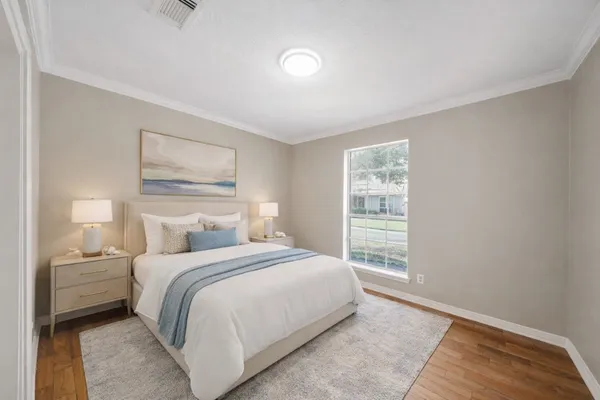 a bedroom with a bed and a window