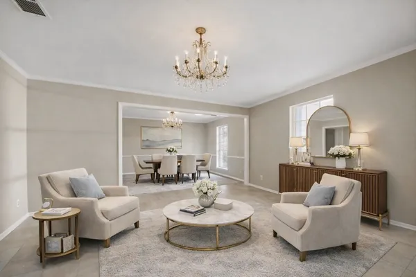 a living room with furniture and a chandelier