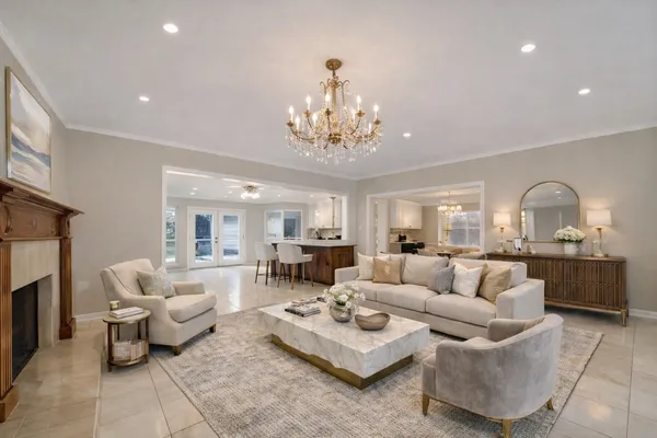 a living room with furniture and a chandelier