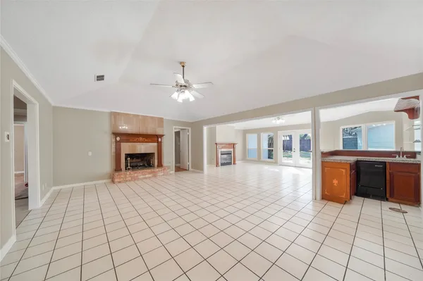a view of an empty room with window and fireplace