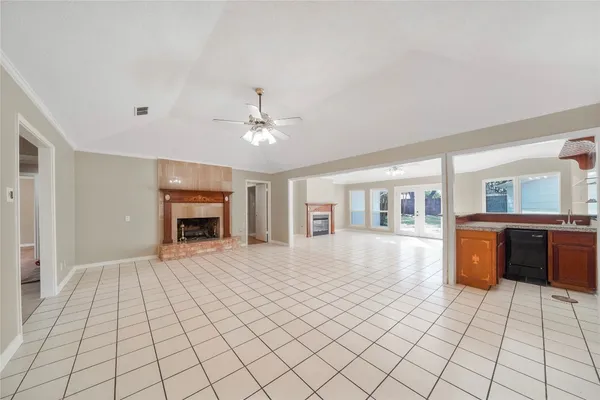 a view of an empty room with window and fireplace
