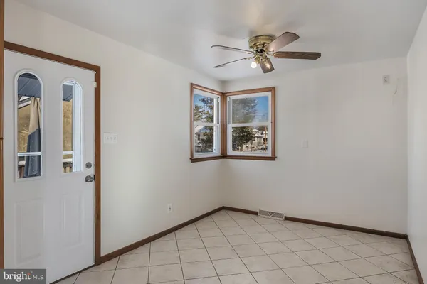 a view of a livingroom with a ceiling fan and window