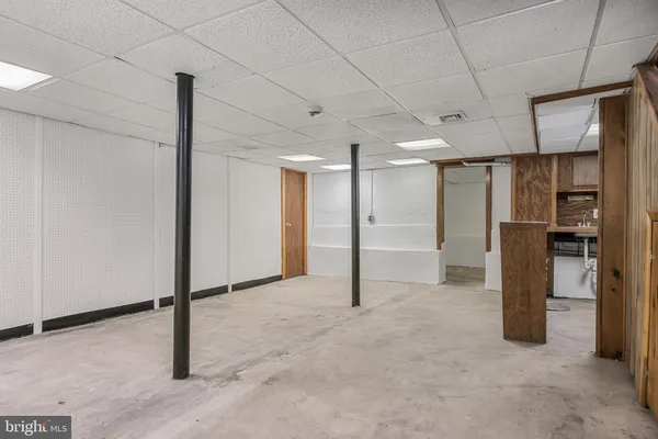 a view of an empty room with a refrigerator