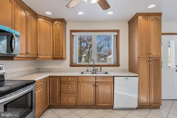 a kitchen with stainless steel appliances wooden cabinets and a sink