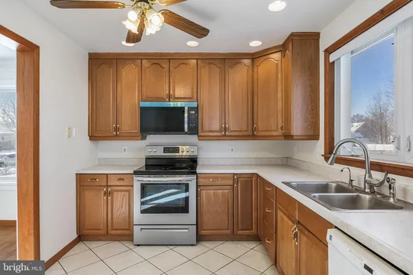 a kitchen with a sink stove and microwave