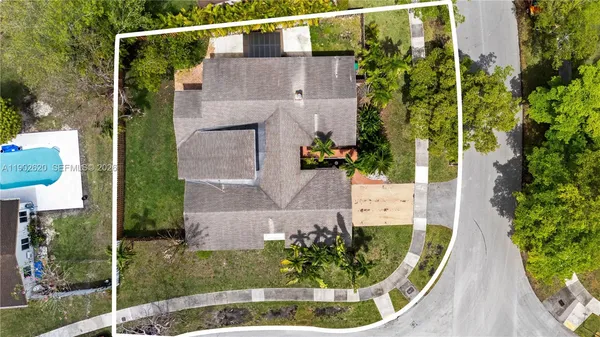 an aerial view of a house with a yard