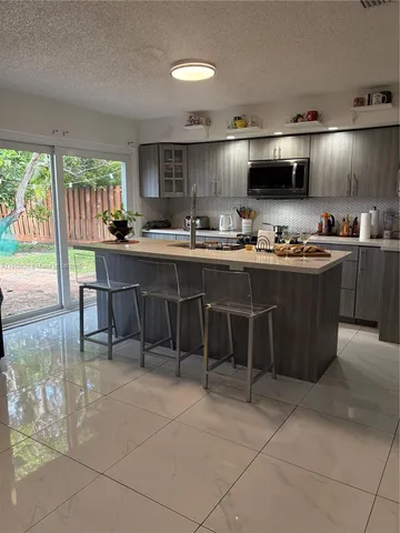 a kitchen with lots of appliances and cabinets