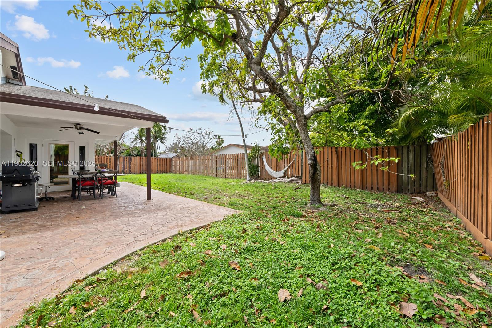 10610 Southwest 128th Avenue Miami, FL 33186 - Photo 14 of 46 a view of a house with backyard and a tree
