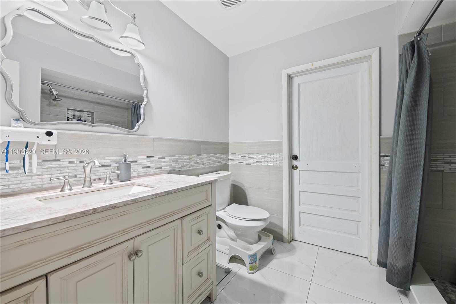 10610 Southwest 128th Avenue Miami, FL 33186 - Photo 18 of 46 a bathroom with a granite countertop sink toilet and shower
