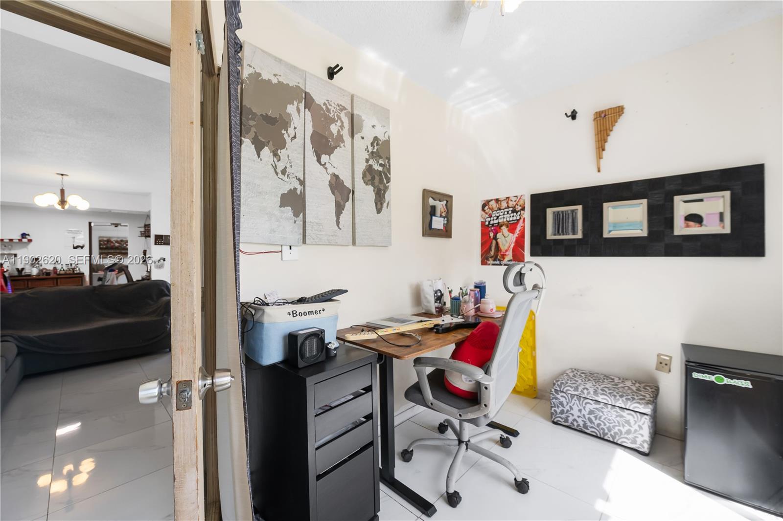 10610 Southwest 128th Avenue Miami, FL 33186 - Photo 24 of 46 a view of a workspace with furniture and a living room