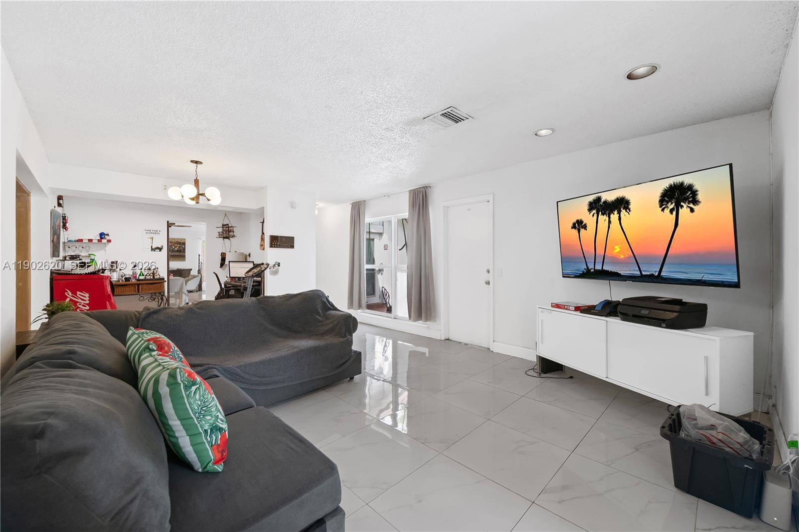 10610 Southwest 128th Avenue Miami, FL 33186 - Photo 25 of 46 a living room with furniture and a flat screen tv