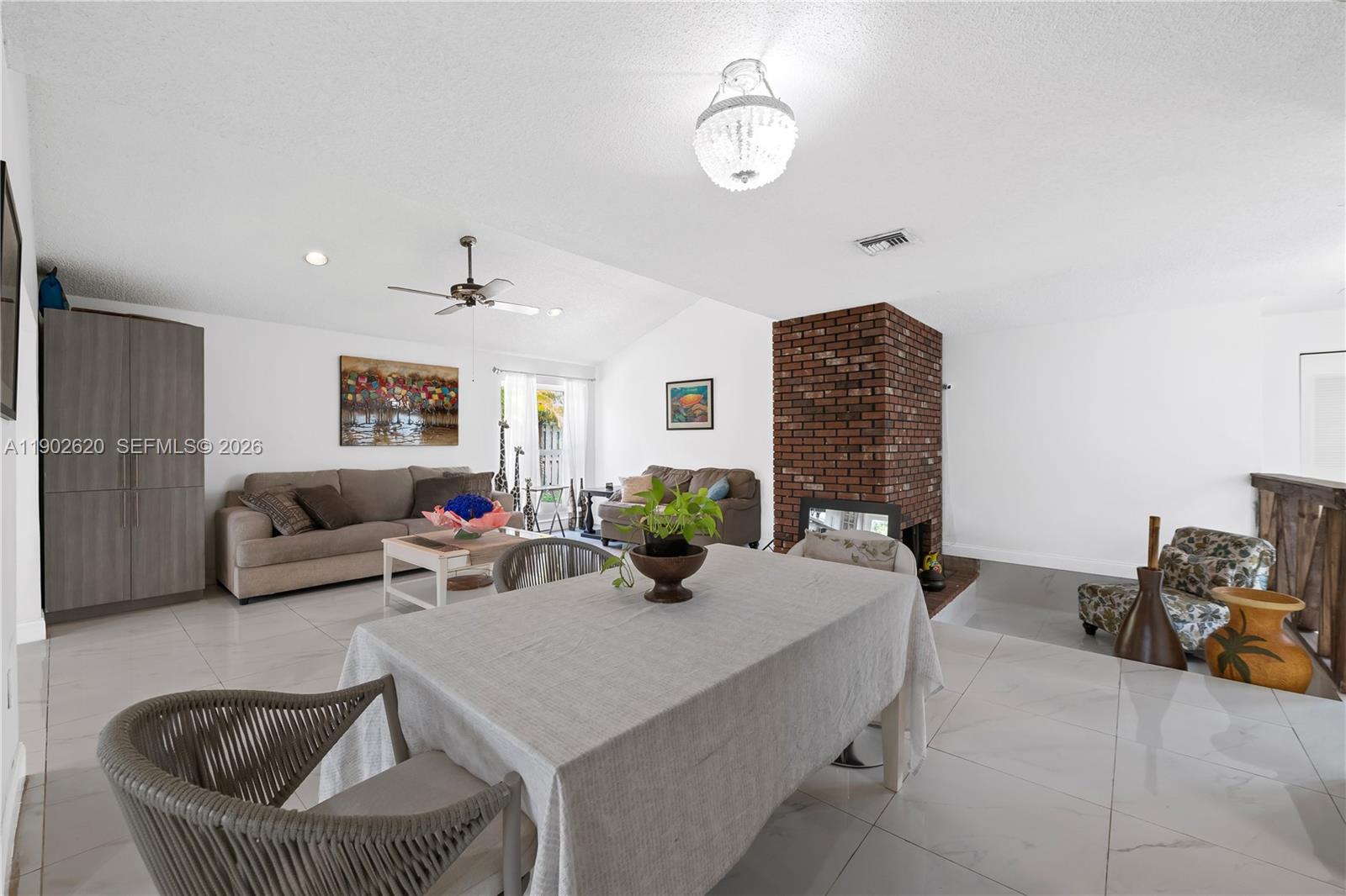 10610 Southwest 128th Avenue Miami, FL 33186 - Photo 32 of 46 a living room with furniture and a fireplace
