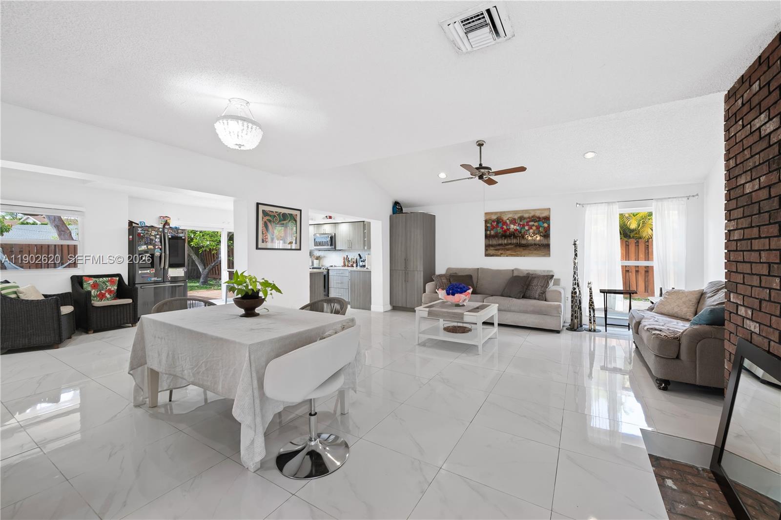 10610 Southwest 128th Avenue Miami, FL 33186 - Photo 33 of 46 a living room with furniture and a chandelier