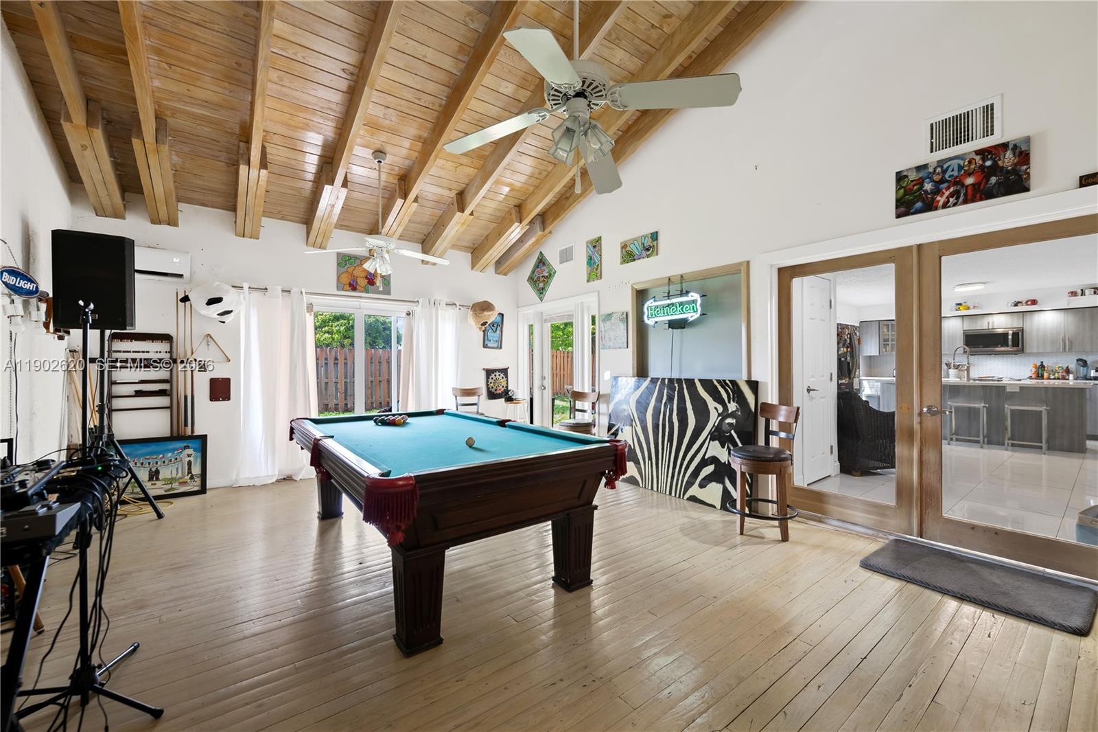 10610 Southwest 128th Avenue Miami, FL 33186 - Photo 39 of 46 a room with furniture and a flat screen tv