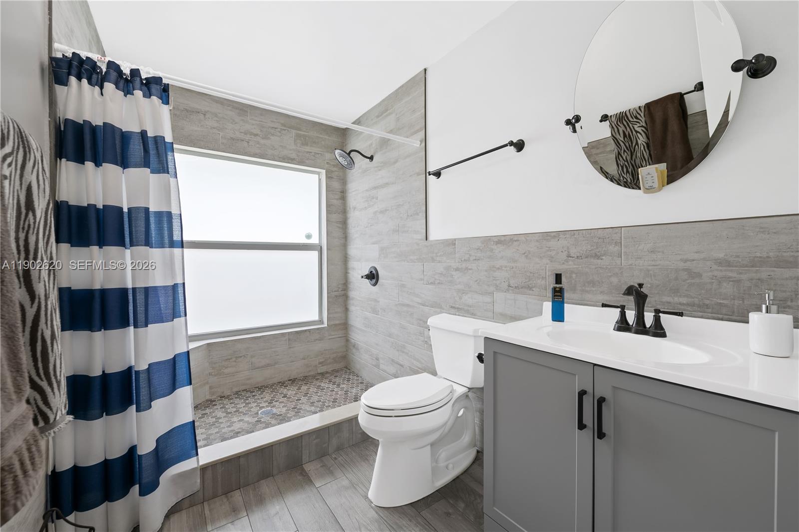 10610 Southwest 128th Avenue Miami, FL 33186 - Photo 41 of 46 a bathroom with a sink a toilet and shower