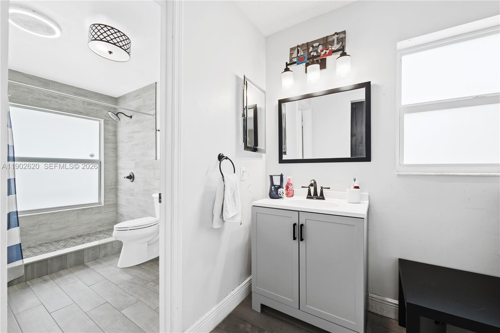 10610 Southwest 128th Avenue Miami, FL 33186 - Photo 42 of 46 a bathroom with a toilet sink and mirror