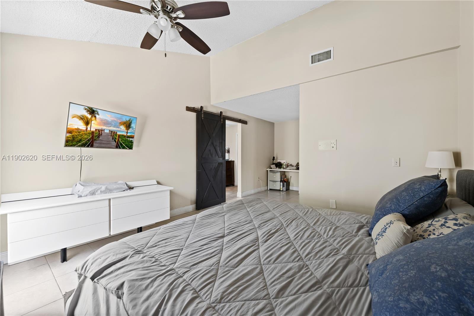 10610 Southwest 128th Avenue Miami, FL 33186 - Photo 46 of 46 a bedroom with a bed and a flat screen tv