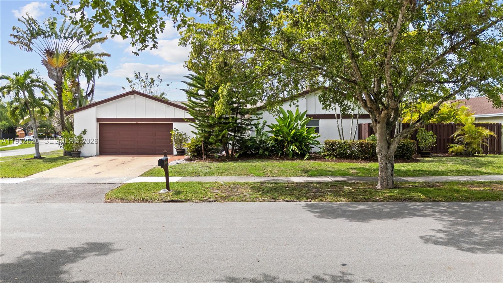 10610 Southwest 128th Avenue Miami, FL 33186 - Photo 5 of 46 a house with garden in front of it