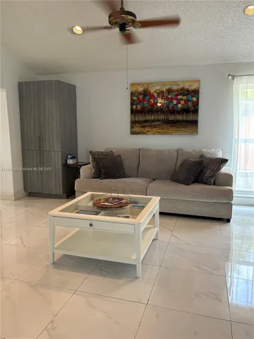 a living room with furniture and a painting on the wall