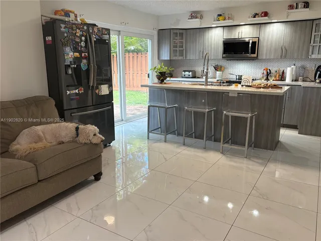 a kitchen with stainless steel appliances a stove a sink and a microwave