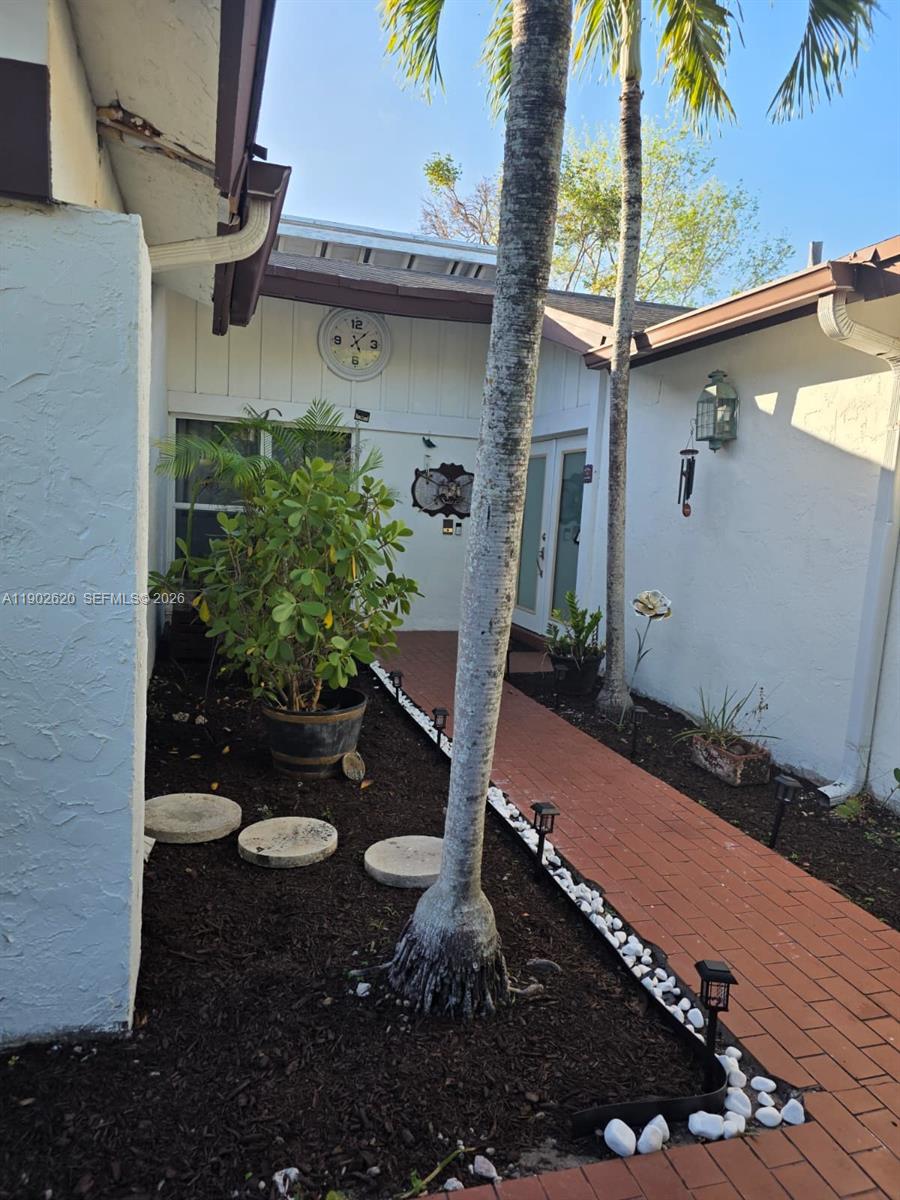 10610 Southwest 128th Avenue Miami, FL 33186 - Photo 10 of 46 a view of a backyard with plants and a patio
