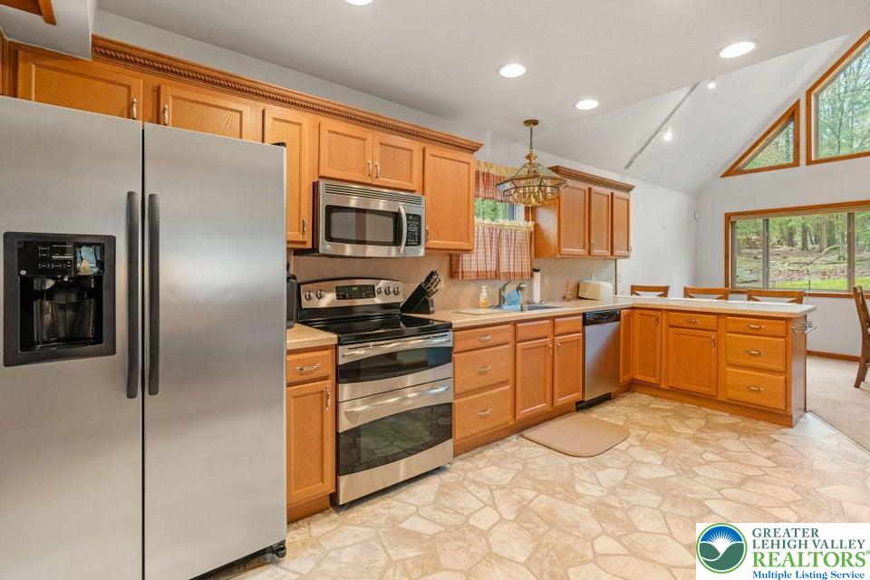 15 Hazard Run Road Lake Harmony, PA 18624 - Photo 11 of 48 a kitchen with stainless steel appliances a refrigerator sink and cabinets