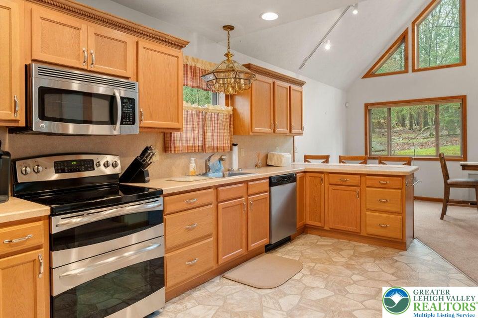 15 Hazard Run Road Lake Harmony, PA 18624 - Photo 12 of 48 a kitchen with a stove a sink and a microwave