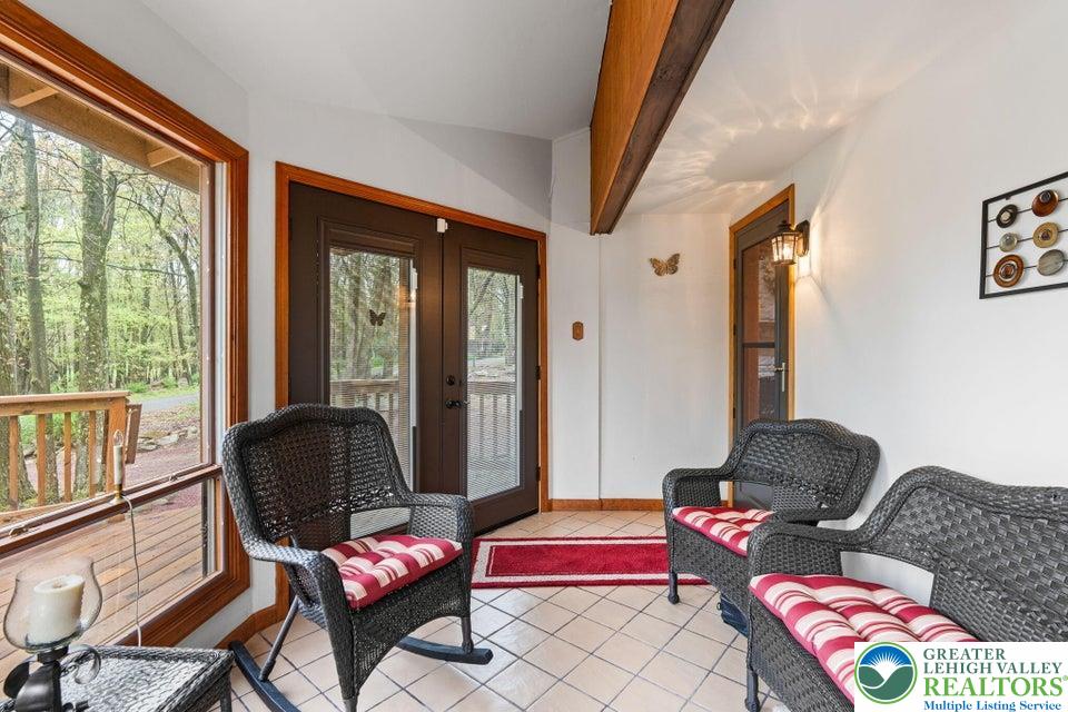 15 Hazard Run Road Lake Harmony, PA 18624 - Photo 18 of 48 a living room with furniture and a floor to ceiling window