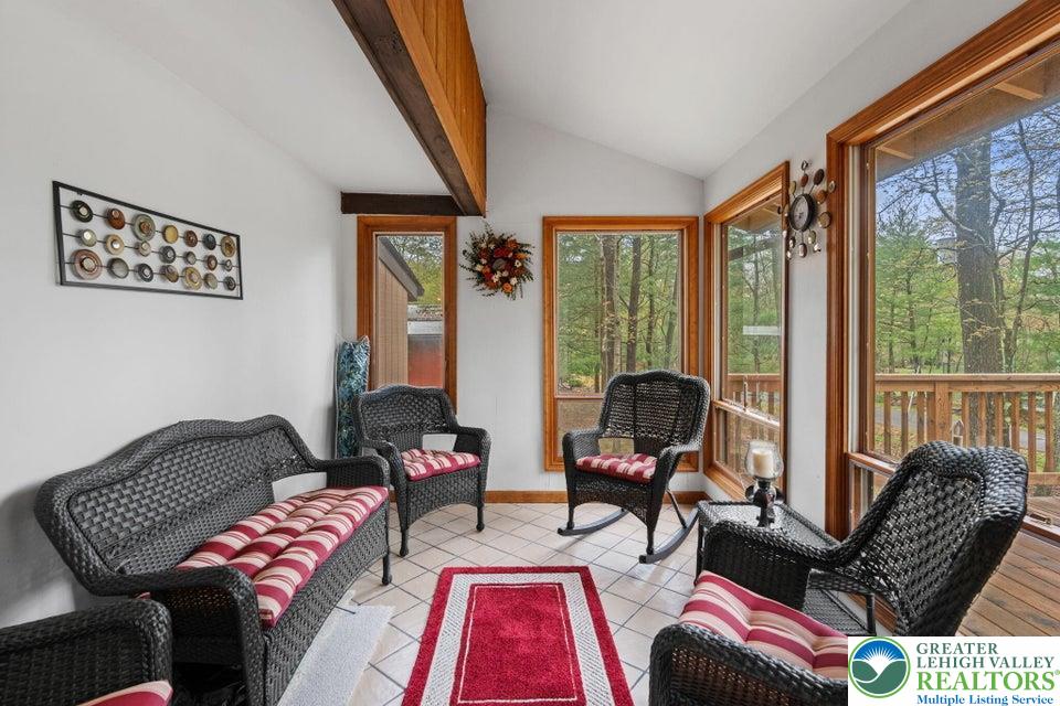 15 Hazard Run Road Lake Harmony, PA 18624 - Photo 20 of 48 a living room with furniture and floor to ceiling windows