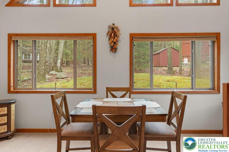 15 Hazard Run Road Lake Harmony, PA 18624 - Photo 21 of 48 a view of a dining room with furniture large windows and a chandelier