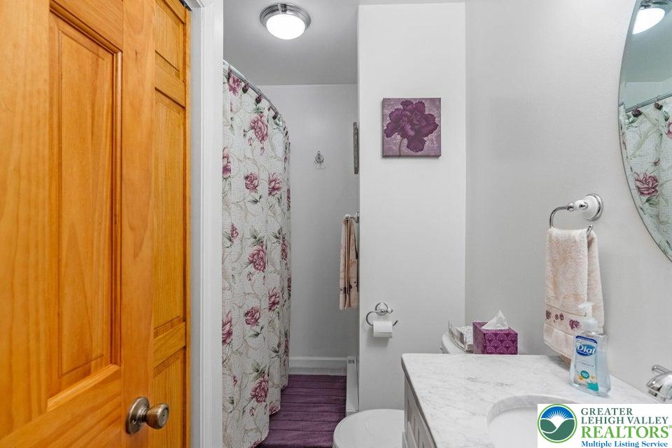 15 Hazard Run Road Lake Harmony, PA 18624 - Photo 28 of 48 a bathroom with a sink toilet and shower curtain