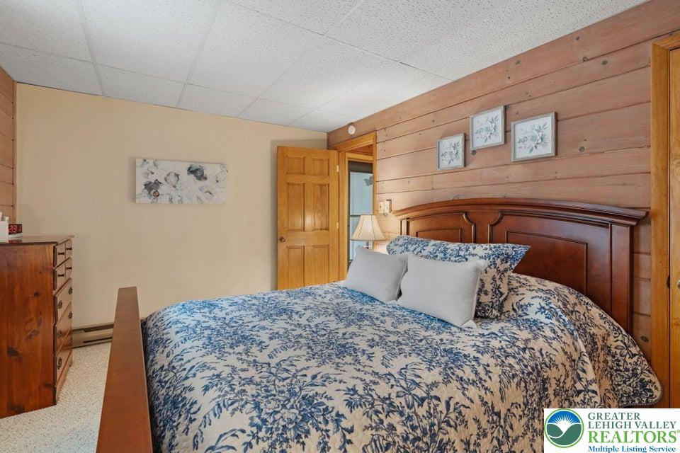 15 Hazard Run Road Lake Harmony, PA 18624 - Photo 30 of 48 a bedroom with a large bed and a couch
