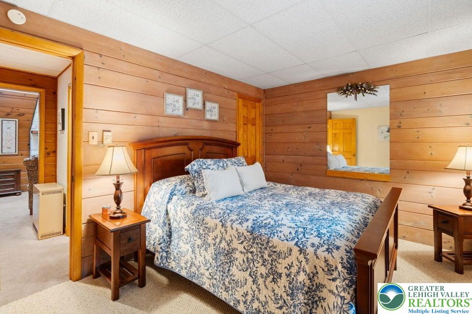 15 Hazard Run Road Lake Harmony, PA 18624 - Photo 31 of 48 a bedroom with a bed and a table in it