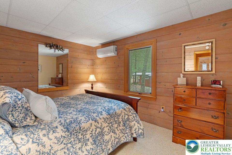 15 Hazard Run Road Lake Harmony, PA 18624 - Photo 32 of 48 a bedroom with a bed and a dresser next to a window