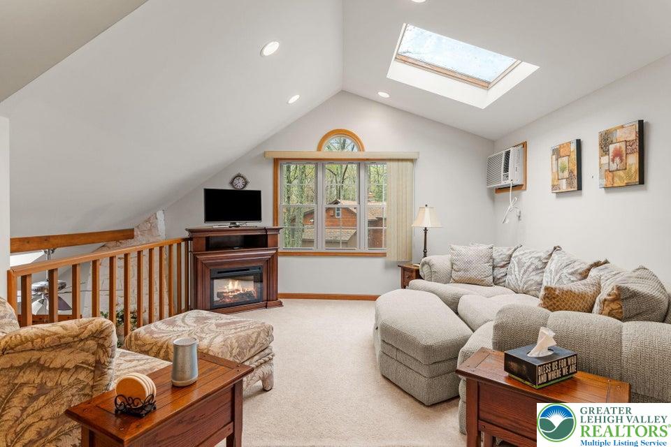 15 Hazard Run Road Lake Harmony, PA 18624 - Photo 35 of 48 a living room with furniture a fireplace and a flat tv screen