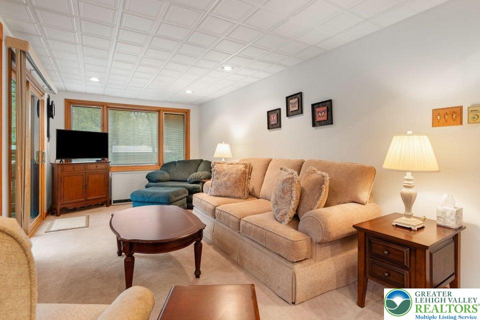 15 Hazard Run Road Lake Harmony, PA 18624 - Photo 39 of 48 a living room with furniture a flat screen tv and kitchen view