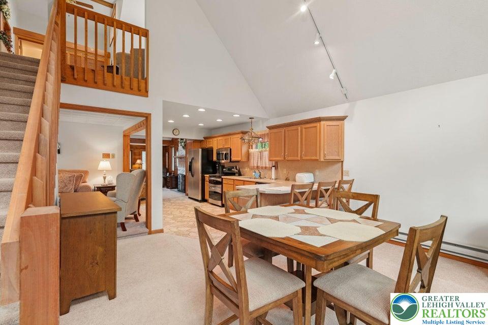 15 Hazard Run Road Lake Harmony, PA 18624 - Photo 6 of 48 a view of a dining room and livingroom with furniture wooden floor a rug a fireplace and a chandelier
