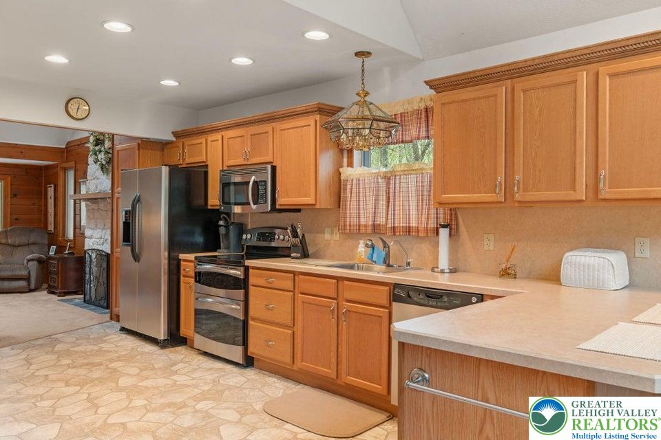 15 Hazard Run Road Lake Harmony, PA 18624 - Photo 9 of 48 a kitchen that has a sink stainless steel appliances a counter top space cabinets and a window