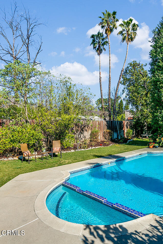 2040 North Madison Avenue Altadena, CA 91001 - Photo 32 of 53 a view of a swimming pool with a yard and palm trees