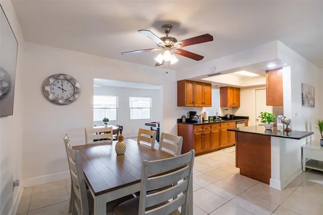 a kitchen with a dining table and chairs
