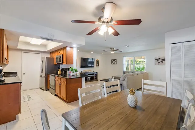a living room with furniture a flat screen tv and kitchen view