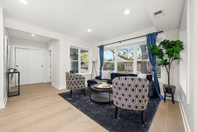 a bedroom with furniture and a large window