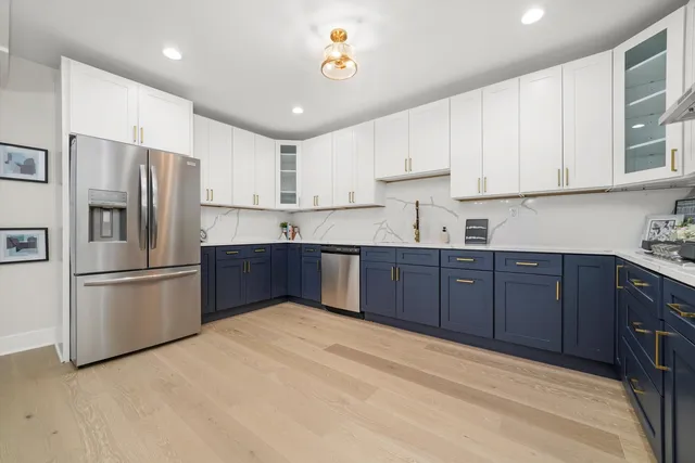 a kitchen with stainless steel appliances granite countertop a refrigerator sink and cabinets
