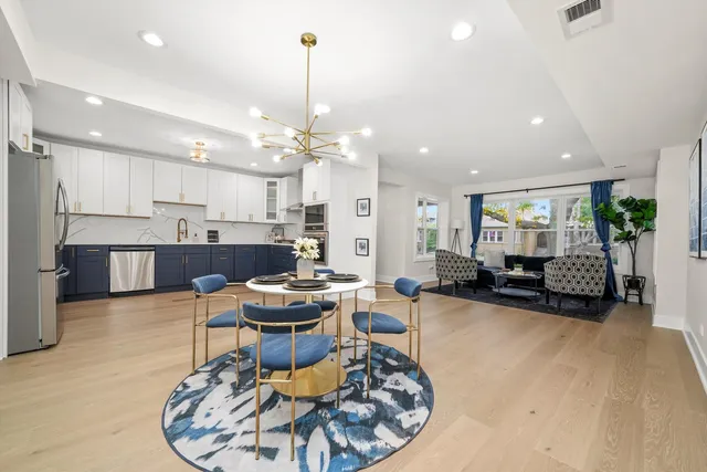 a living room with furniture and kitchen view