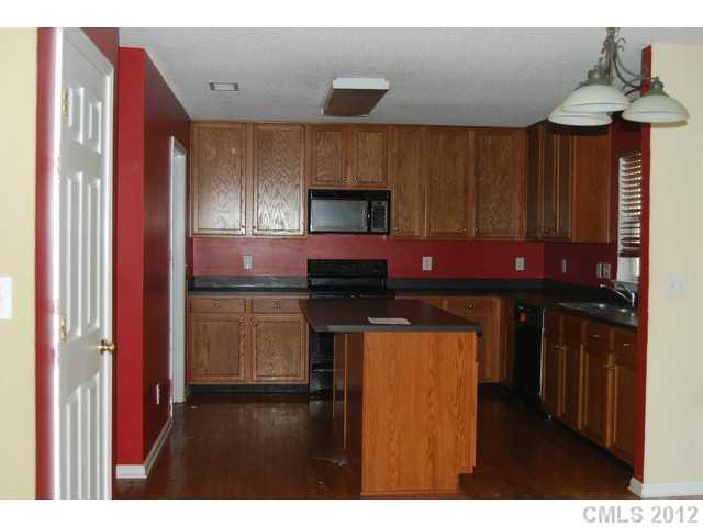 104 Austin Run Court Kannapolis, NC 28083 - Photo 2 of 16 a kitchen with stainless steel appliances granite countertop a stove and cabinets